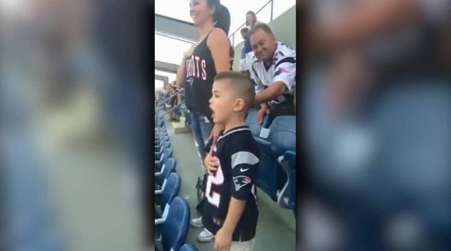 Young boy sings the national anthem