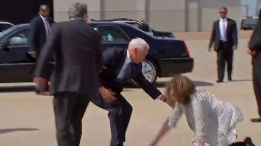 Pence helps a woman who tripped getting off Air Force Two