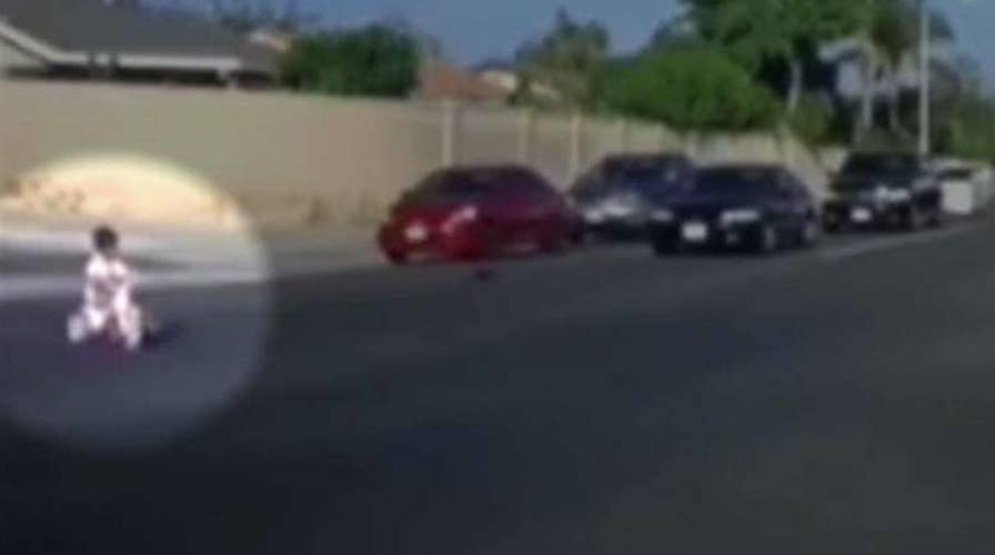 Cars narrowly miss boy on tricycle who rolled into traffic