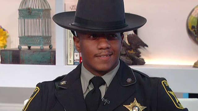 Image result for Security Guard Pardoned on Gun Charge Achieves Dream of Becoming a Cop