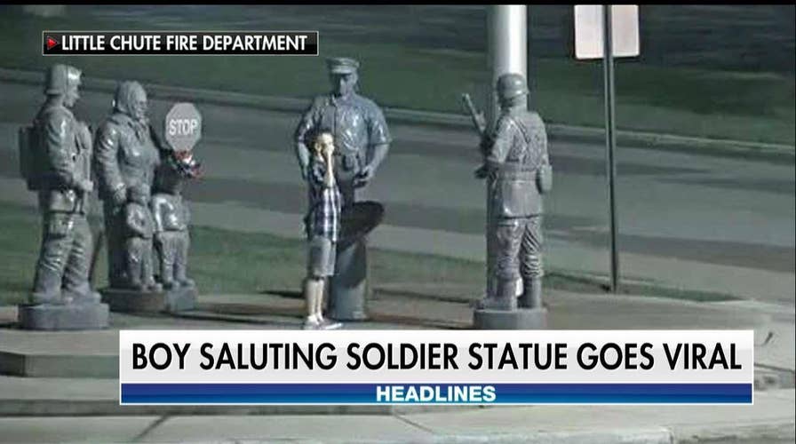 Touching Photo Captures Young Boy Saluting Soldier's Statue at Memorial