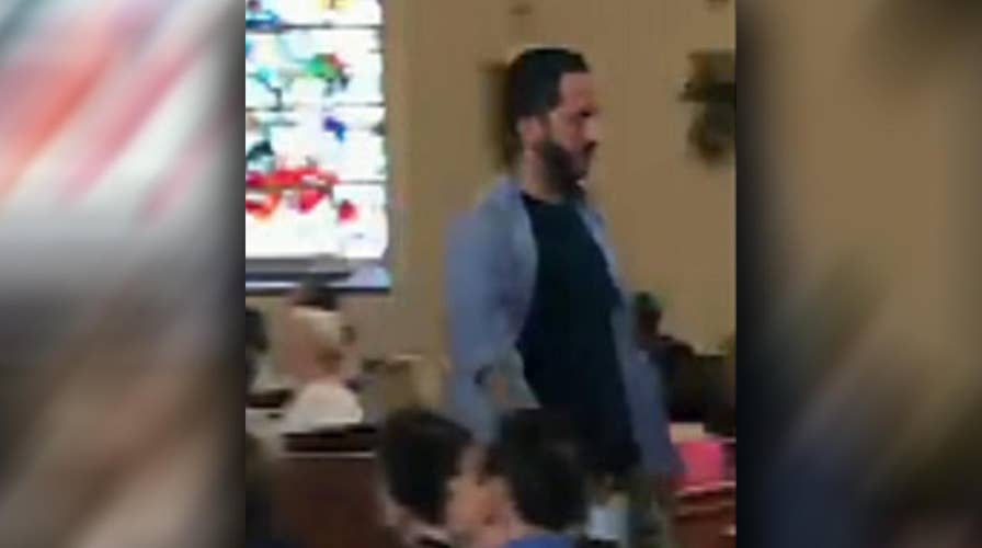 Man shouts 'Shame on you' during embattled priest's address