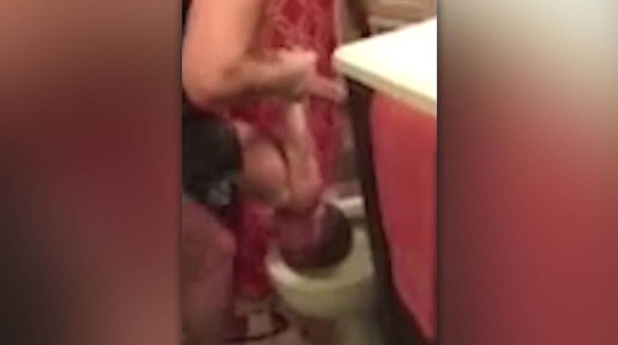 Outrage over video of mother dunking child's head in toilet