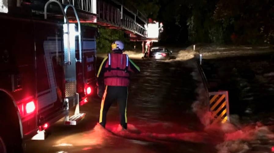 Father, sons rescued from Maserati trapped in floodwaters