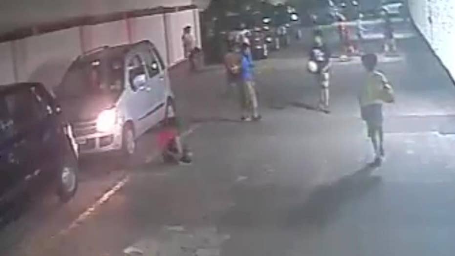 Kid tying shoelace run over by car, walks away Fox News