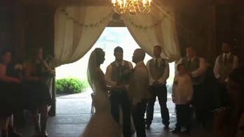 Wedding photographer praised after video of her pushing stepmother out of the way at ceremony goes viral