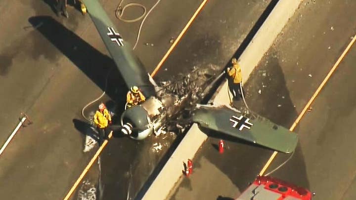 Vintage plane crashes on busy highway not far from Los Angeles