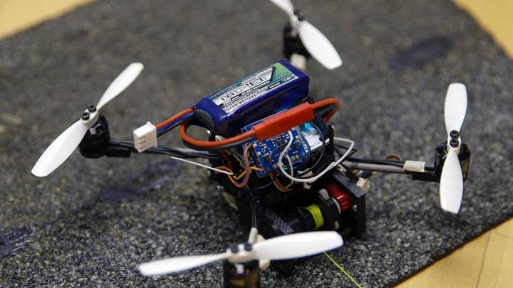 Tiny flying robots haul heavy loads in amazing video