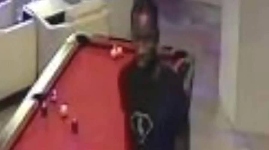 Surveillance video: Suspect captured punching man at bar