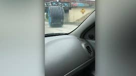 Giant industrial spool rolls down highway as cars try to dodge it