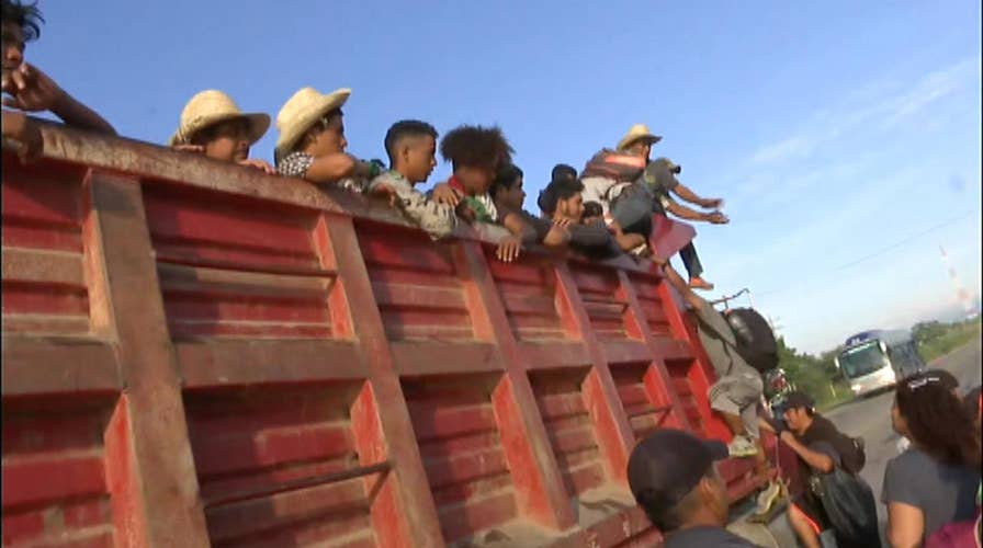 Migrants board trucks en route to Mexico City