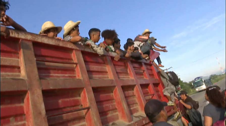 Migrants board trucks en route to Mexico City