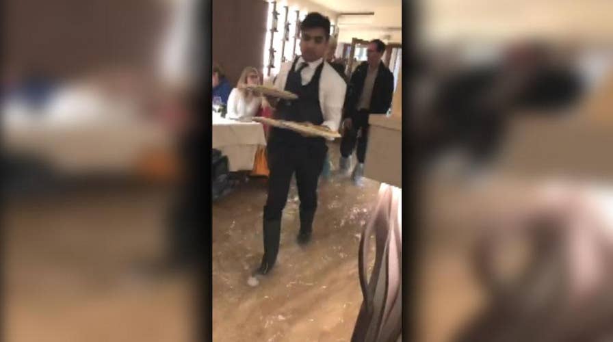 Pizzeria in Italy continues to serve food while flooded