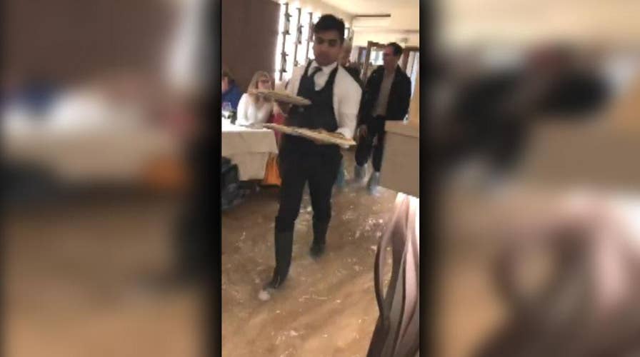 Pizzeria in Italy continues to serve food while flooded