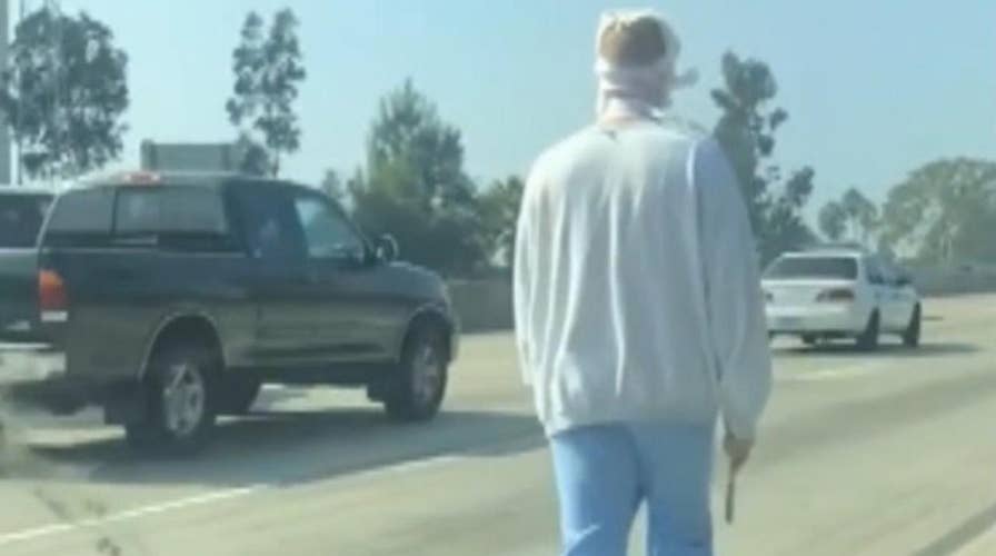 Knife-wielding man with bandages on face wanders LA freeway