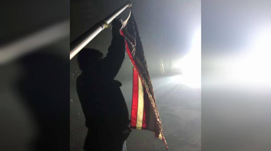 American flag stands in ashes of California wildfire