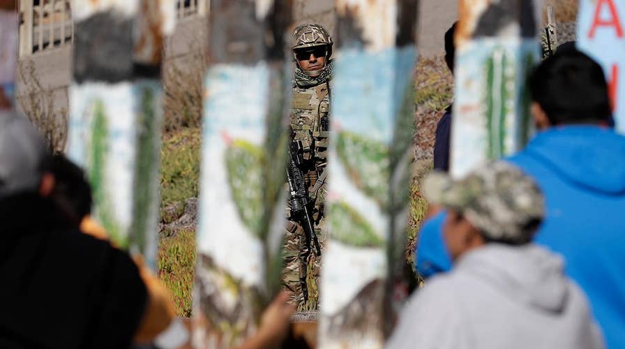 New focus on wall funding as migrants reach US border