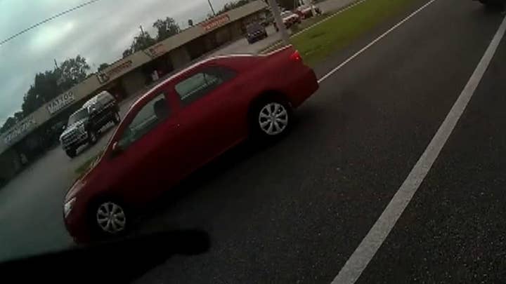 Sheriff's deputies stop cars that drove by a stopped bus