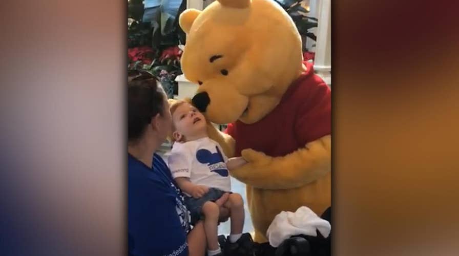 Winnie the Pooh shares tender moment with disabled child