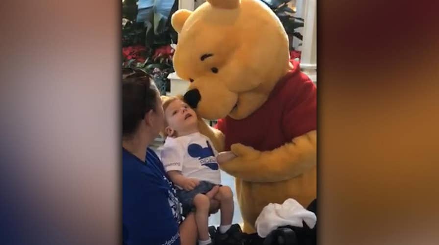 Winnie the Pooh shares tender moment with disabled child