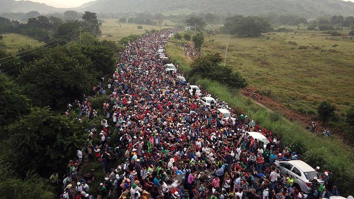 Migrants gather at new shelter area in Tijuana