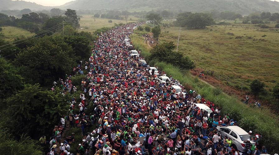 Caravan migrants begin to breach border as frustration with slow