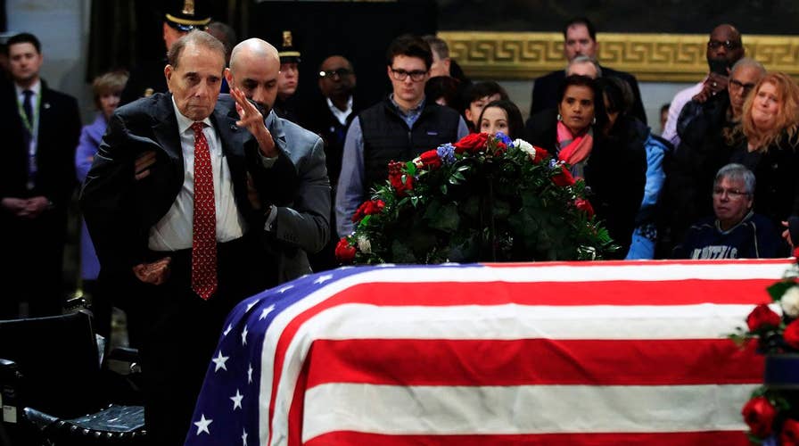 Fellow war hero Bob Dole honors George H.W. Bush
