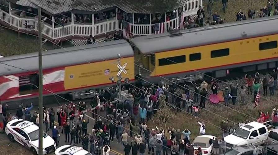 Members of the public salute Bush 41's funeral train