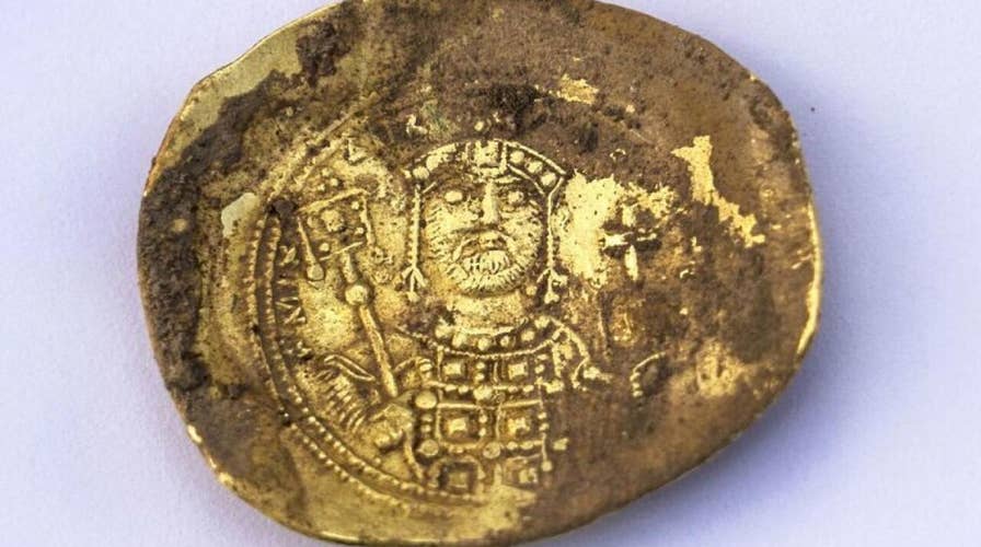Trove of coins and 900-year-old earring found at massacre site