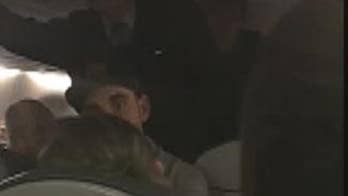 United Airlines passenger praises 'hero' who helped woman suffering seizures during flight