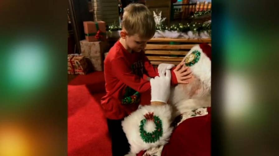 Blind, autistic boy 'sees' Santa for first time