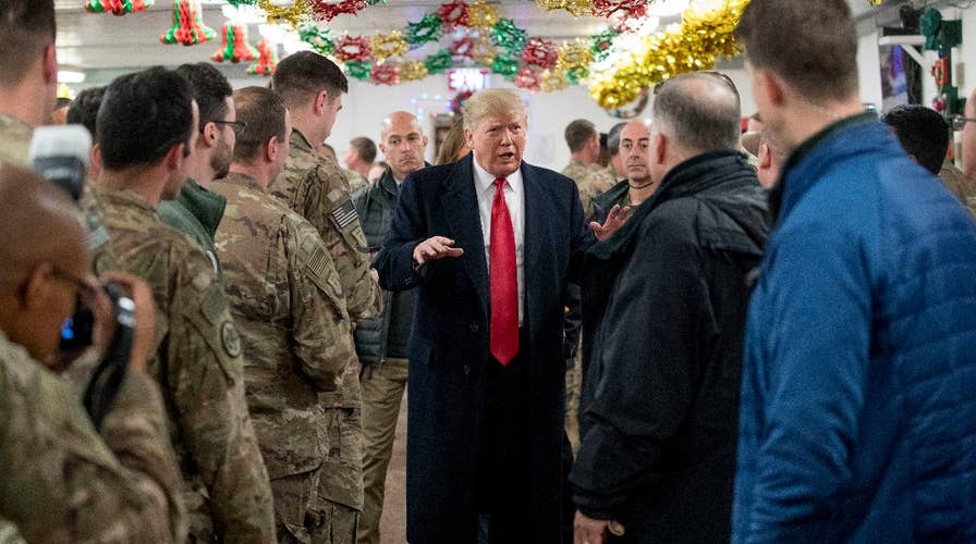 What message is President Trump sending with his unannounced visit to US troops deployed in Iraq?