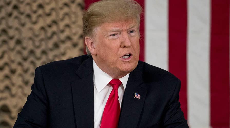 President Trump pledges to do whatever it takes to get the border wall during his surprise visit to US troops in Iraq