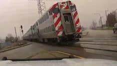 Frightening dashcam footage shows Illinois police officer swerving out of the way of train