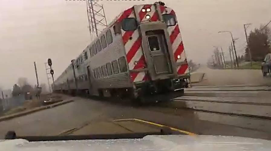 Cop nearly crashes into oncoming train after crossing gates fail to lower