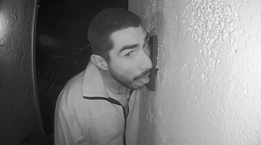 Man caught on surveillance camera licking intercom system for hours