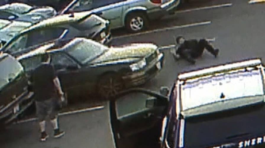 Surveillance video shows teen suspect ram her car into police officer in Washington
