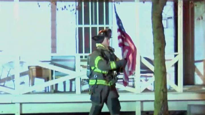 Firefighter, navy veteran saves home owner's American flag from burning Ohio home moments before the house collapses