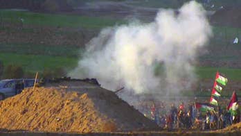 Israeli forces fire tear gas at Palestinian protesters on the Gaza border
