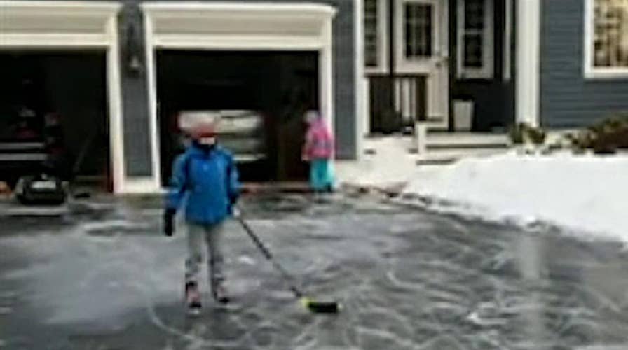 Kids make the most of the winter storm that turned their driveway into an ice rink