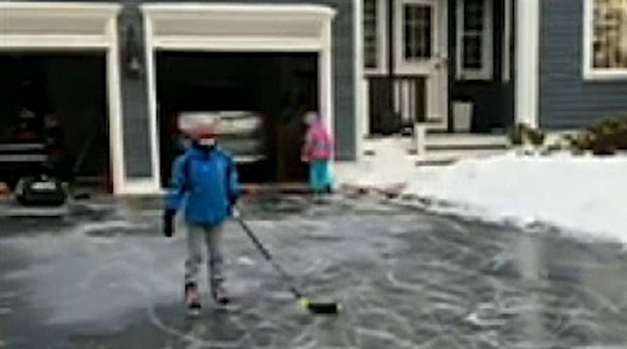 Kids make the most of the winter storm that turned their driveway into an ice rink