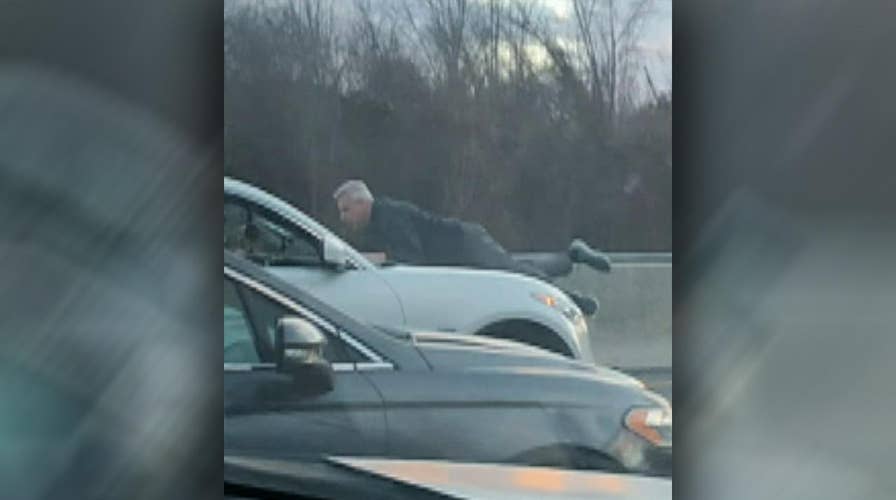 Raw video: Man holds on to hood of speeding car