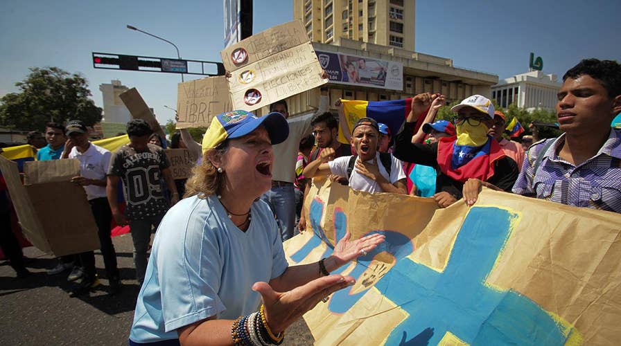 Demonstrators in Venezuela take to the streets to show support for opposition leader Guaido.