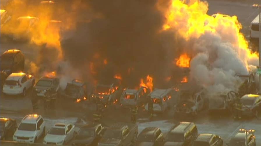 Firefighters worked to put out a raging fire at a Newark Airport parking garage; no injuries reported