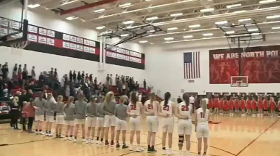 Iowa crowd sings national anthem at high school basketball game