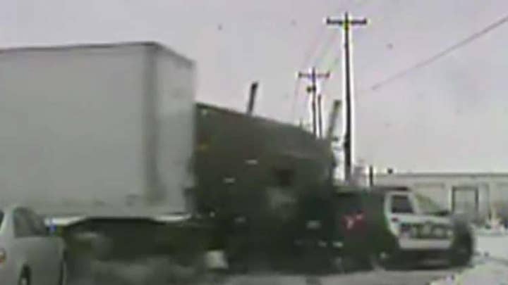 Semi-truck runs light, slams into police cruiser in Wisconsin