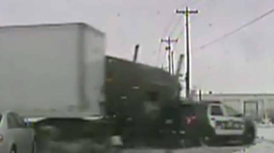Semi-truck runs light, slams into police cruiser in Wisconsin