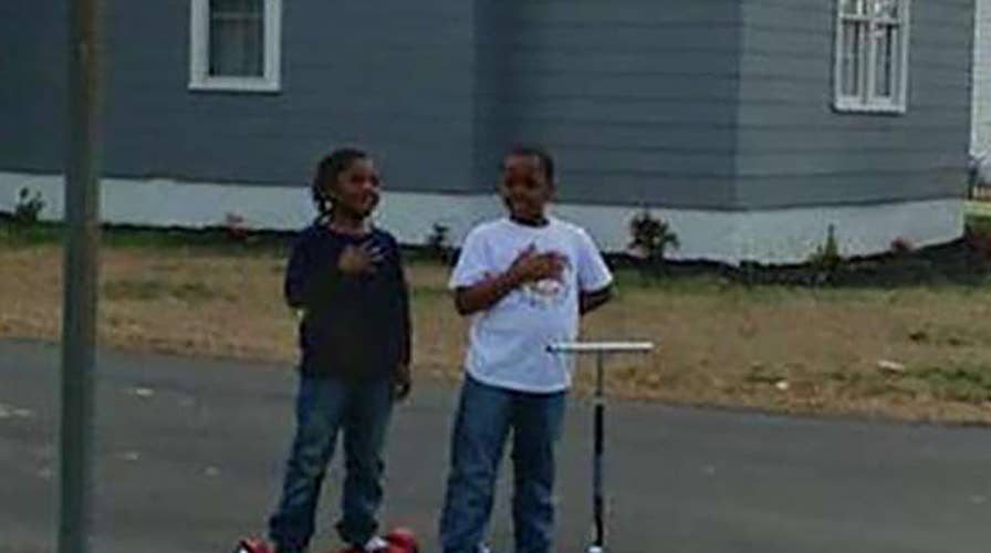 Two young patriots salute the flag outside a North Carolina firehouse