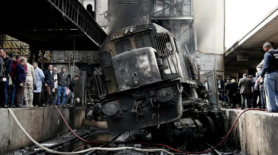 Dozens killed in Cairo station after train slams into barrier causing an explosion that triggered a fire