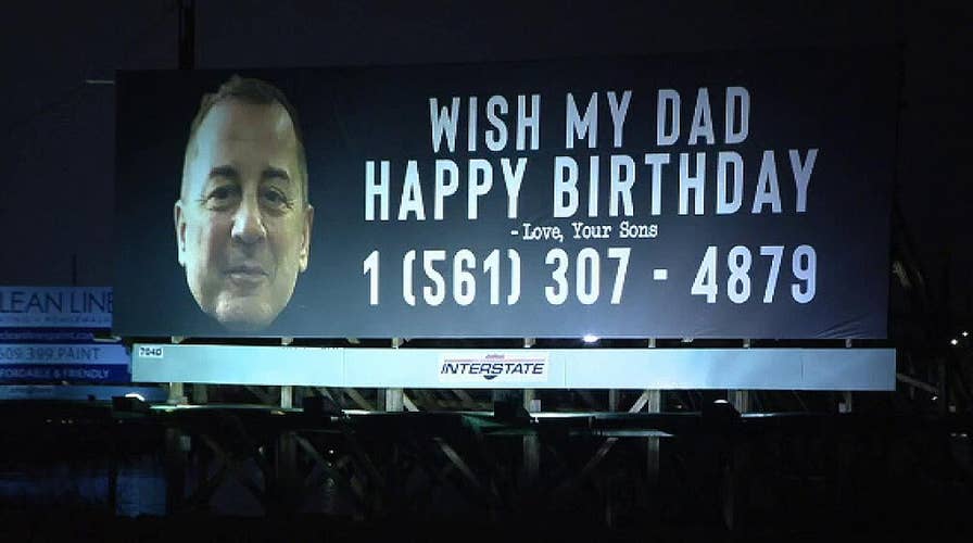 Sons rent billboard advertising dad's birthday and phone number